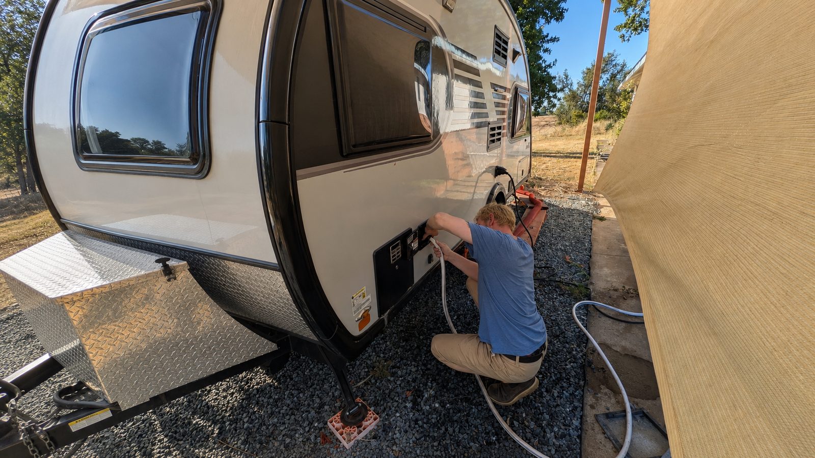 Mobile RV technician servicing a travel trailer
